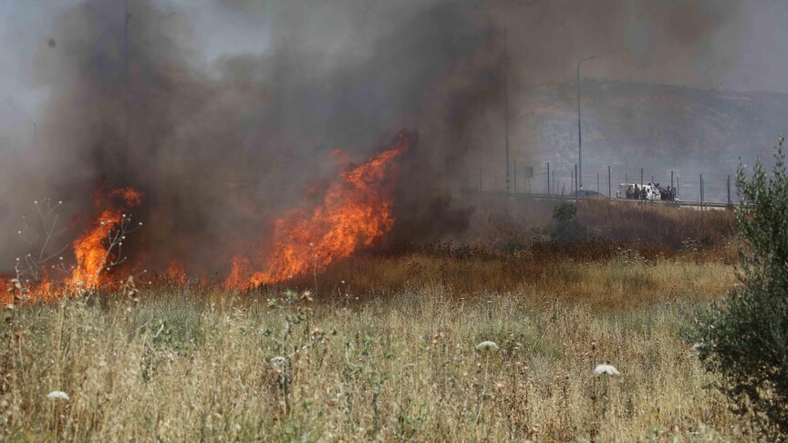 Israeli settlers set fire to Palestinians' agricultural fields in the West Bank